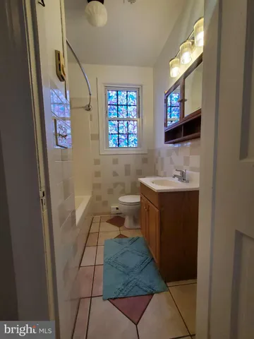 a bathroom with a sink a mirror and a toilet