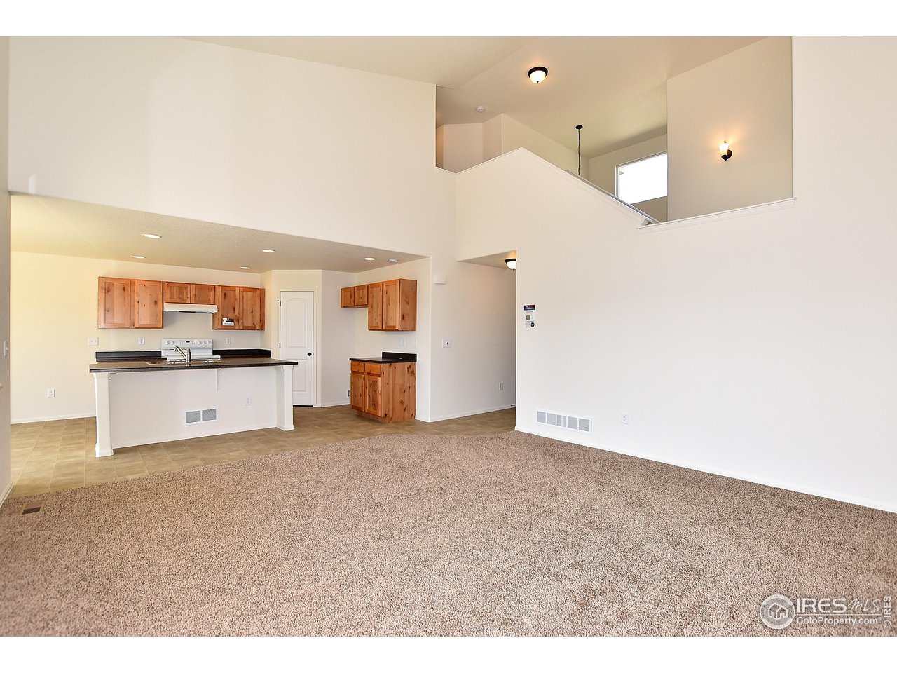 2270 Sublime Drive Windsor, CO 80550 - Photo 11 of 39 a view of a kitchen with furniture and an empty room