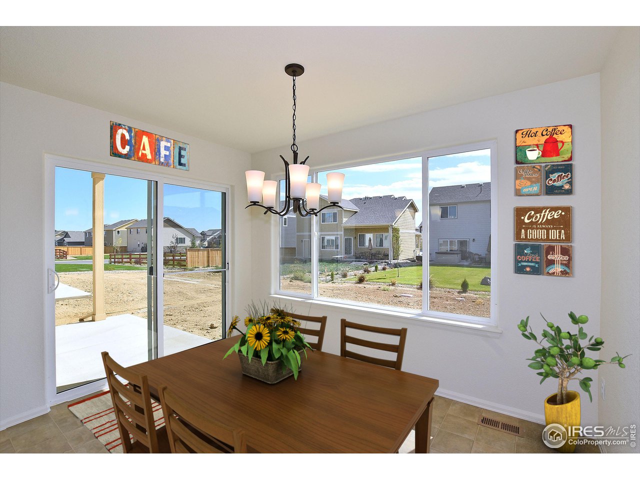 2270 Sublime Drive Windsor, CO 80550 - Photo 6 of 39 a dining room with furniture a chandelier and wooden floor