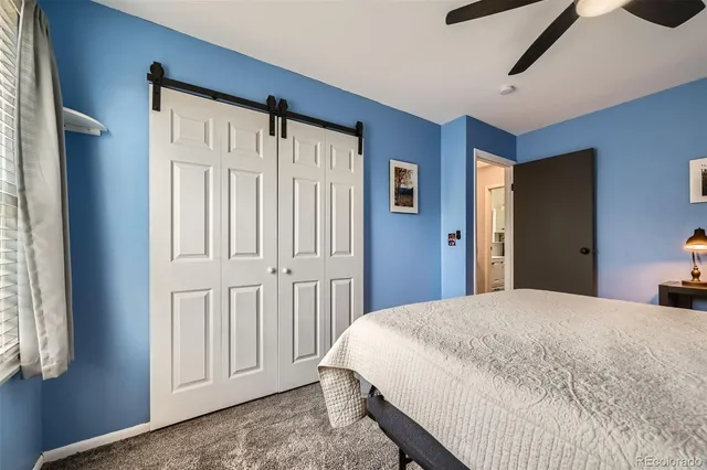 a bedroom with a large bed and a window