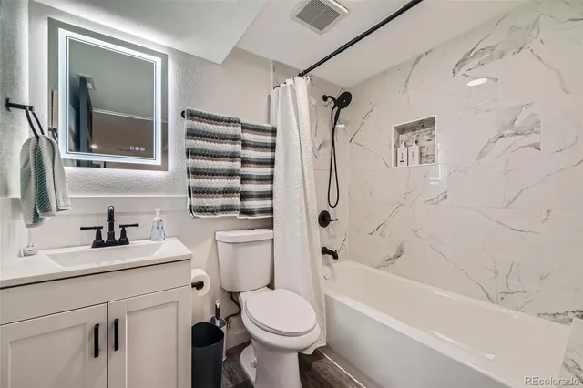 a bathroom with a sink toilet and shower