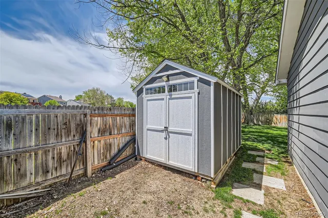 a white house that has tree in front of it