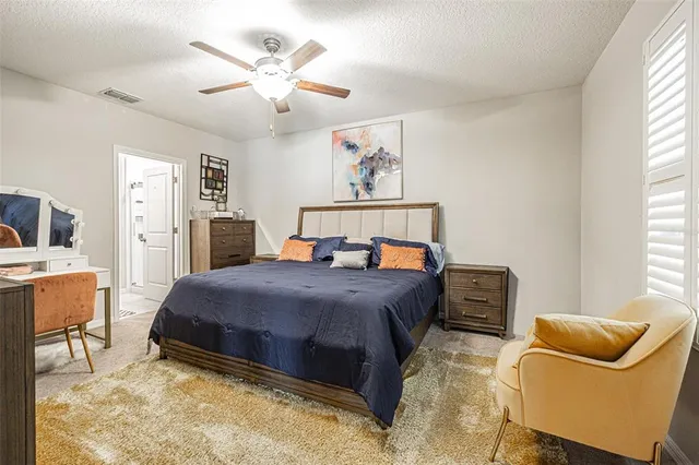 a bathroom with a granite countertop sink a mirror and a shower