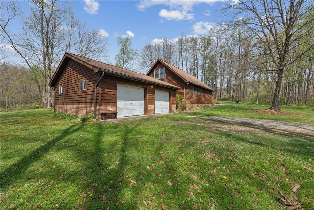 136 Bottom Road Mill Run, PA 15464 - Photo 2 of 26 a front view of a house with a garden