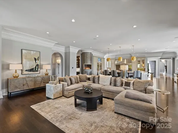 a living room with fireplace furniture and a large window