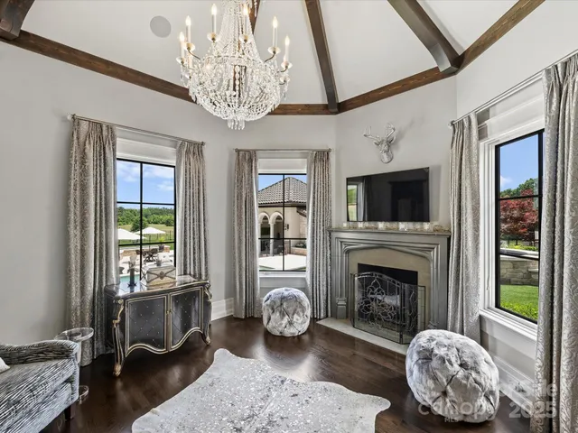 a room with gym equipment and view of kitchen