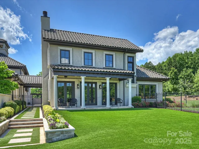 a spacious bedroom with a bed couch and window