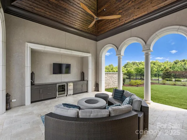 a view of a patio with dining table and chairs
