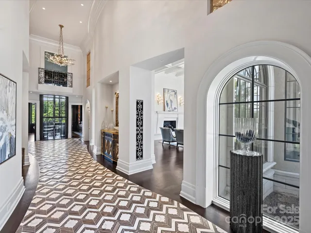 a living room with couches a dining table and chairs with outer view