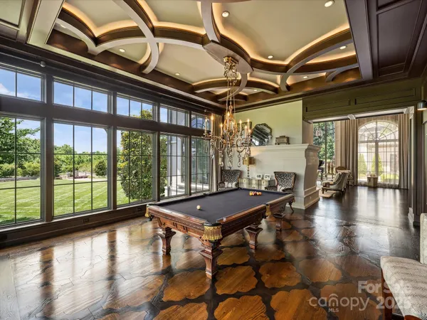 a living room with furniture and a floor to ceiling window