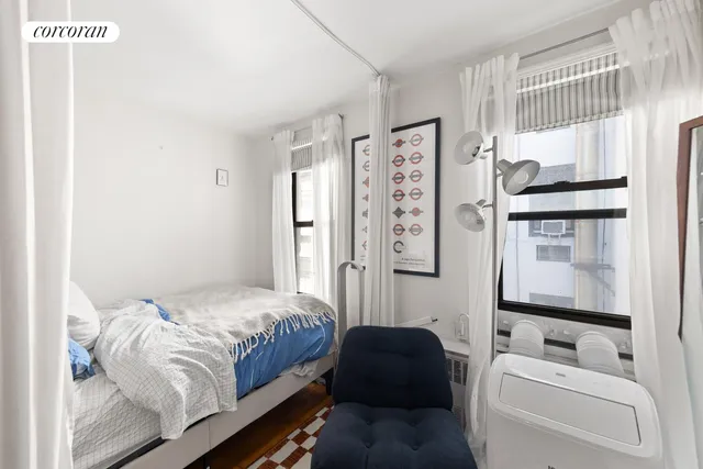 a bedroom with a bed couch and a window