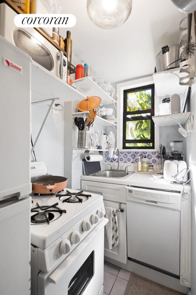 238 East 30th Street, Unit 3E Manhattan, NY 10016 - Photo 4 of 5 a kitchen with a stove and a sink