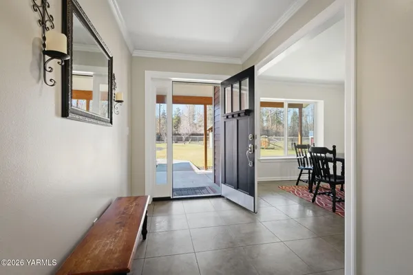 a view of a hallway with dining area and chandelier