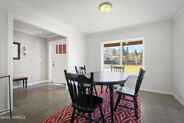 a view of a dining room with furniture and a window