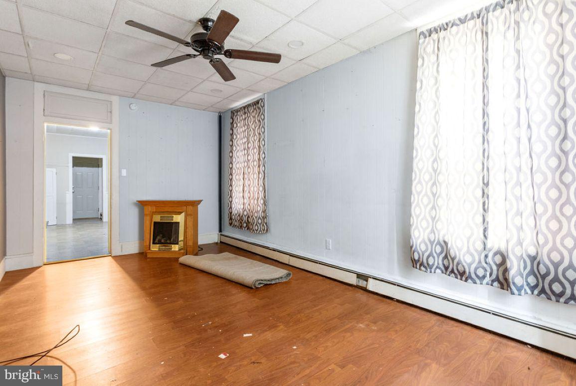 138 Pleasant Street Hanover, PA 17331 - Photo 20 of 39 a view of an empty room with a fireplace and a window
