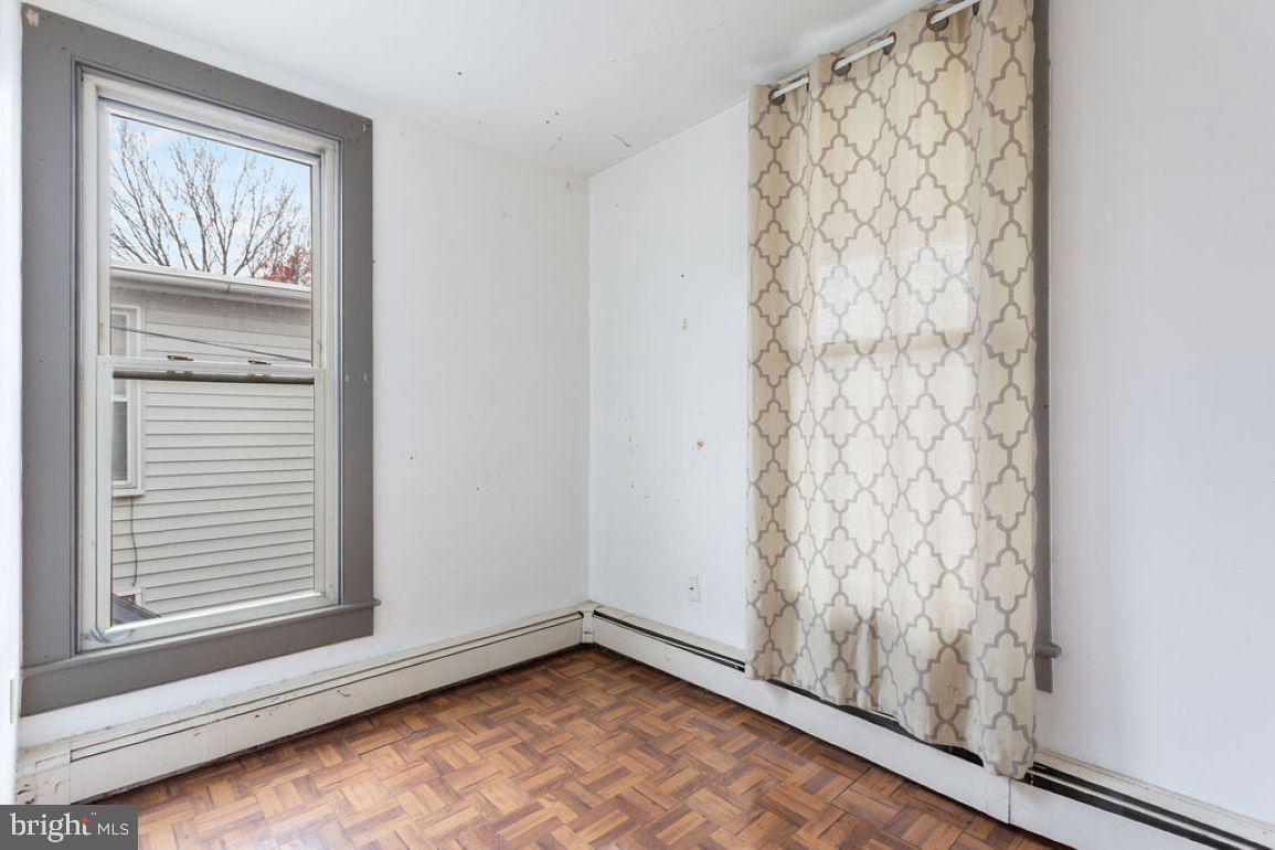 138 Pleasant Street Hanover, PA 17331 - Photo 30 of 39 a view of an empty room with a window and hardwood floor