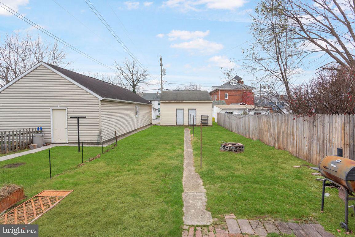 138 Pleasant Street Hanover, PA 17331 - Photo 38 of 39 a view of a backyard with table and chairs and wooden fence