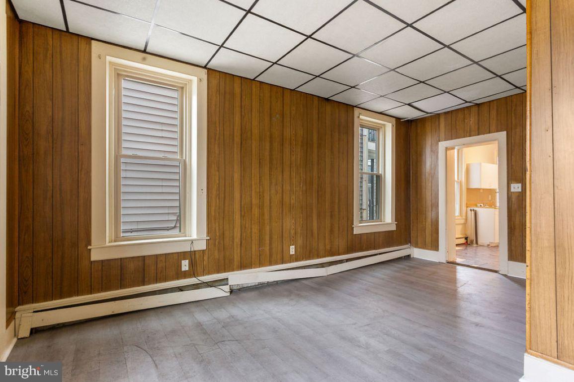 138 Pleasant Street Hanover, PA 17331 - Photo 6 of 39 an empty room with wooden floor and windows