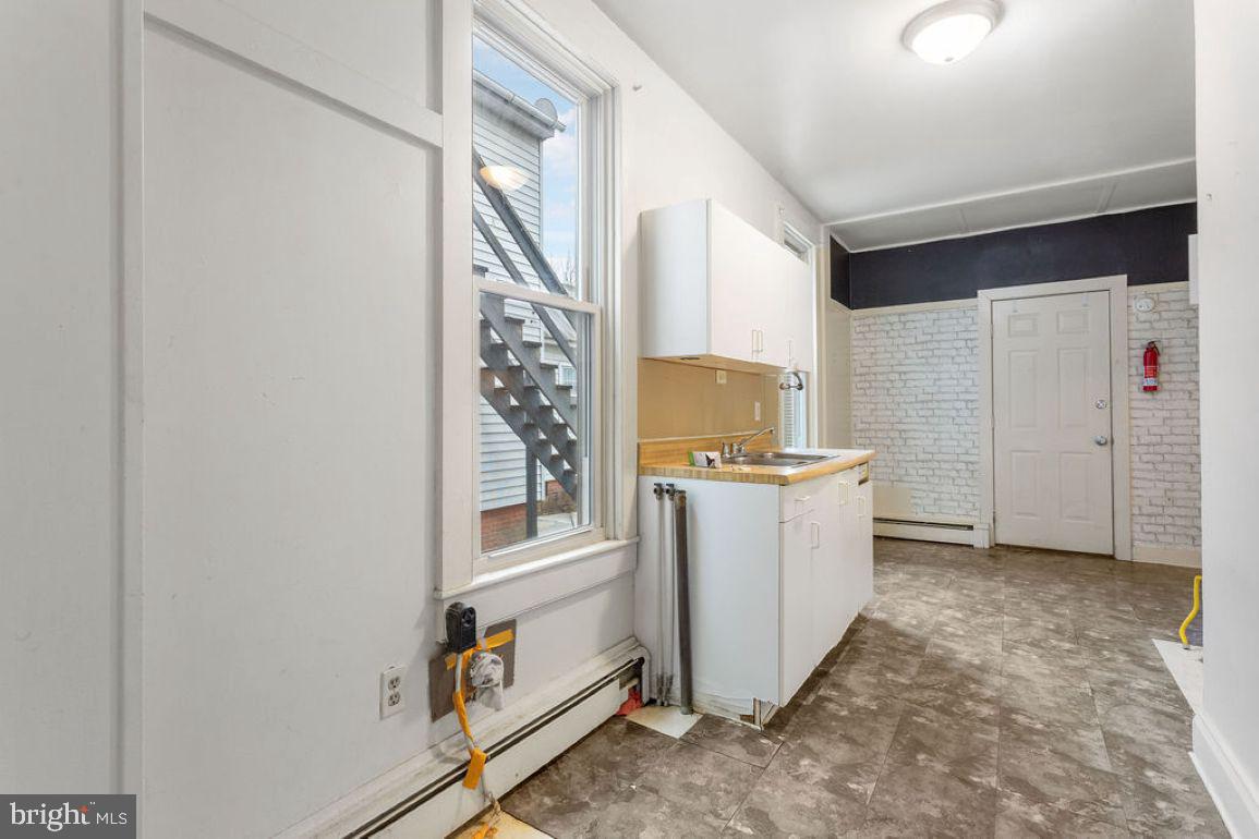 138 Pleasant Street Hanover, PA 17331 - Photo 7 of 39 a kitchen with a refrigerator and white cabinets