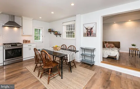 a view of a dining room with furniture and wooden floor