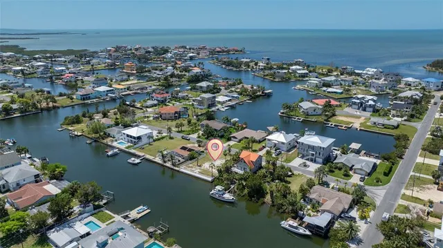 an aerial view of a city with lots of residential buildings ocean and boats
