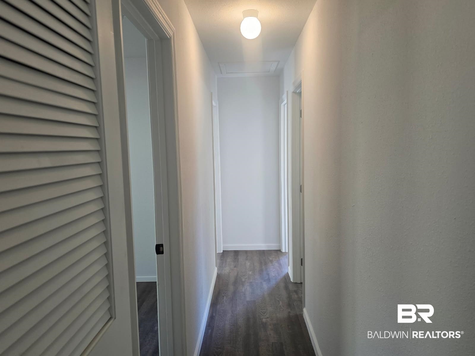 1404 Dailey Street Brewton, AL 36426 - Photo 12 of 25 Hallway featuring dark wood-type flooring and baseboards