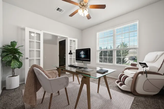 a living room with furniture and a large window