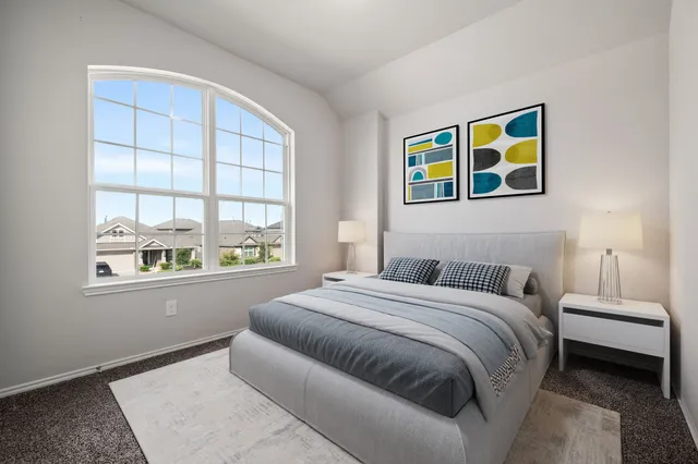 a bedroom with a bed and a potted plant