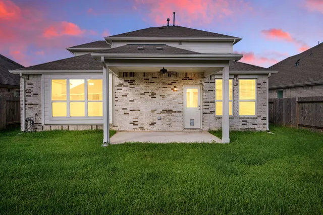 a view of a house with a yard and sitting area
