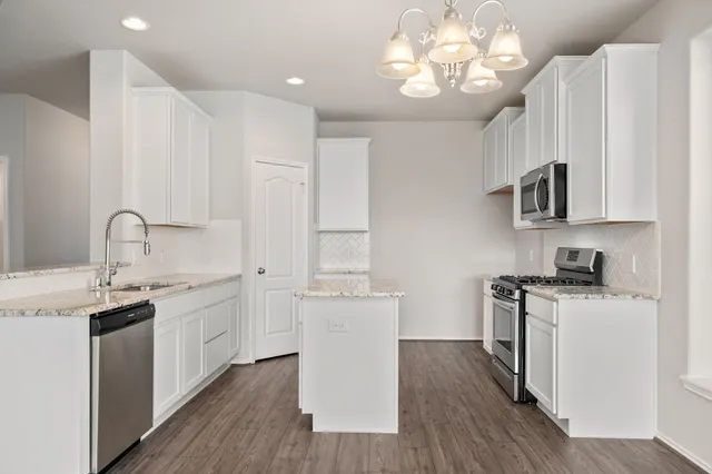 a bedroom with a bed a couch and a potted plant