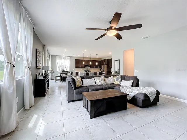 a living room with furniture and kitchen view