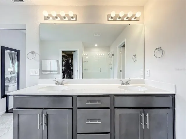 a bathroom with a sink and a mirror