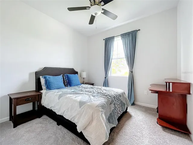 a bedroom with a bed and window