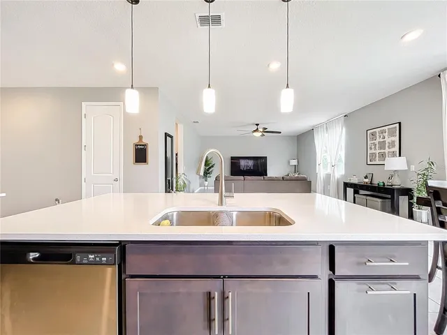 a view of a kitchen counter space a sink and wooden floor