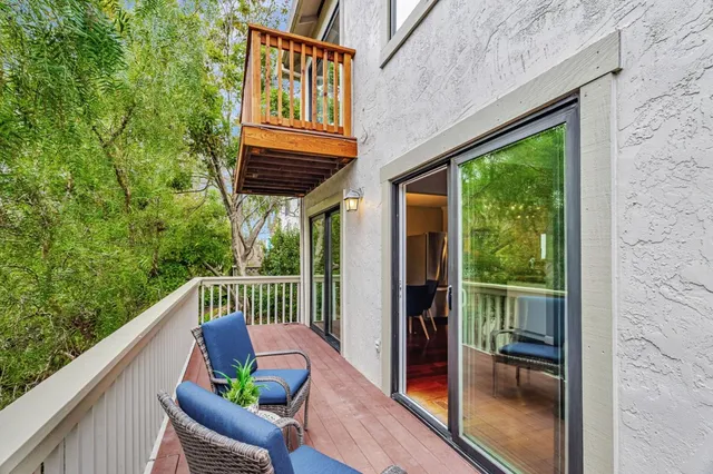 a view of a chair and table in the balcony