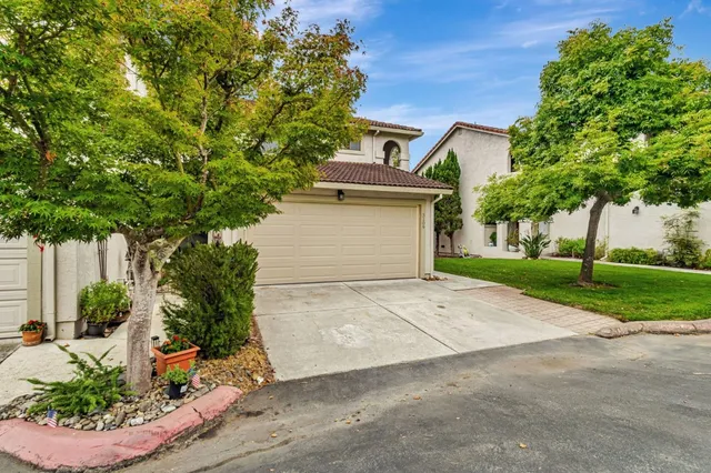 a front view of a house with garden