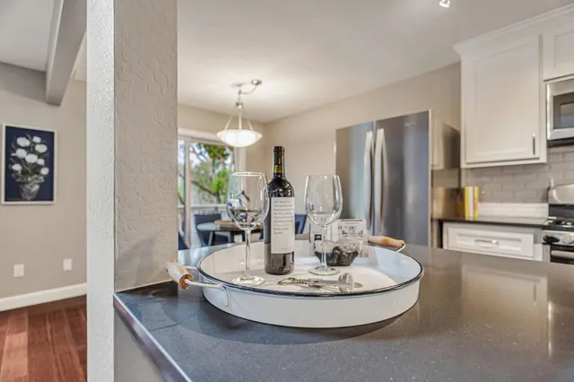 a view of a kitchen with kitchen island a chandelier and living room view