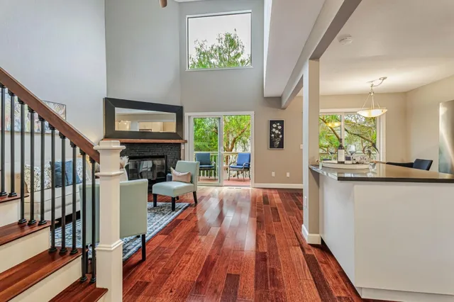 a living room with furniture a fireplace and a wooden floor