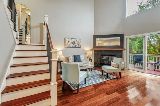 a living room with furniture wooden floor and a fireplace