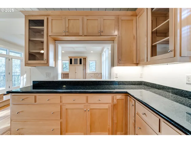 a kitchen with granite countertop a sink and cabinets