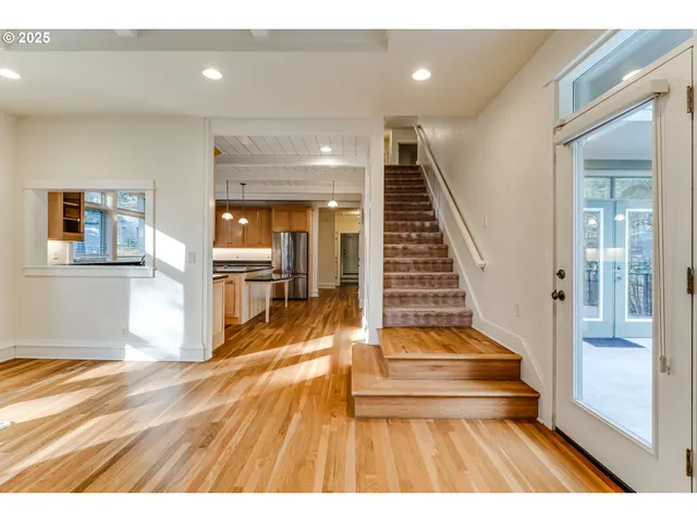 a view of entryway and hall with wooden floor