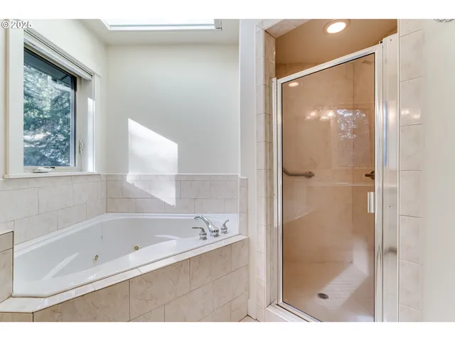 a bathroom with a bathtub and a shower