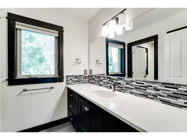 a bathroom with a sink double vanity and a window