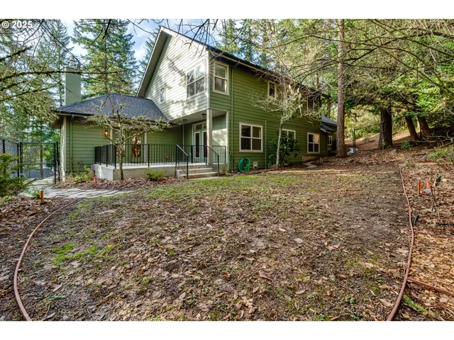 a view of a house with a yard and sitting area