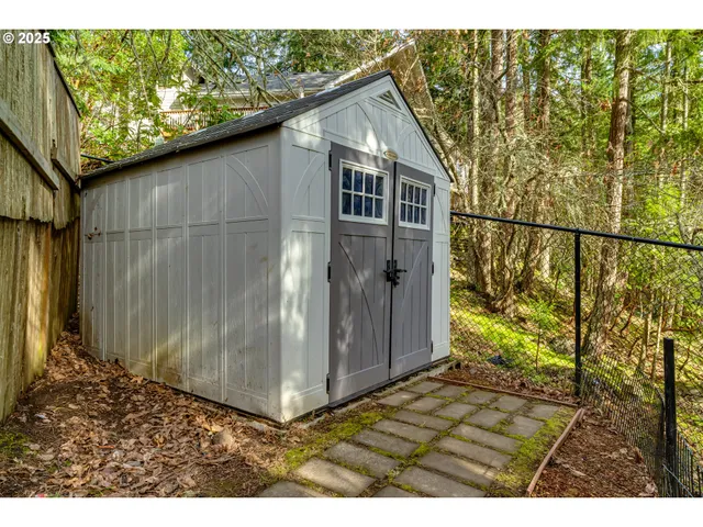 a view of a house with wooden stairs and a small yard