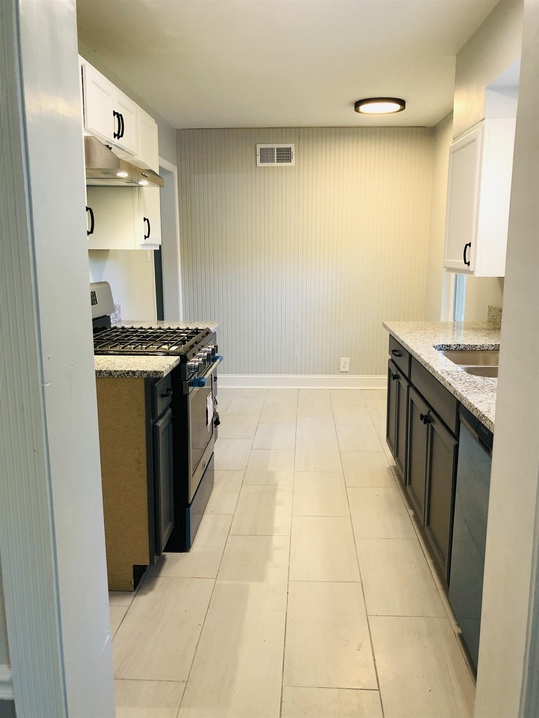 846 McClure Road Memphis, TN 38116 - Photo 5 of 16 a kitchen with stainless steel appliances granite countertop a stove a sink and a refrigerator