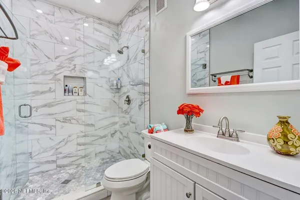 a bathroom with a sink a toilet and a shower curtain