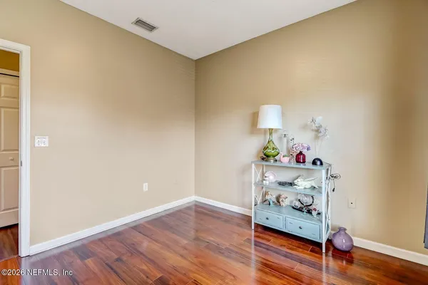 a room with wooden floor and lamp