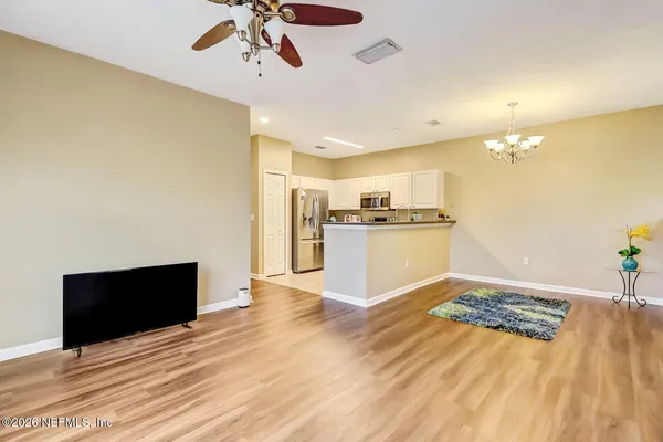 a view of a kitchen with a stove cabinets and wooden floor