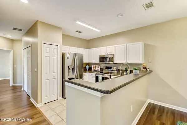 a kitchen with stainless steel appliances a refrigerator stove microwave and sink